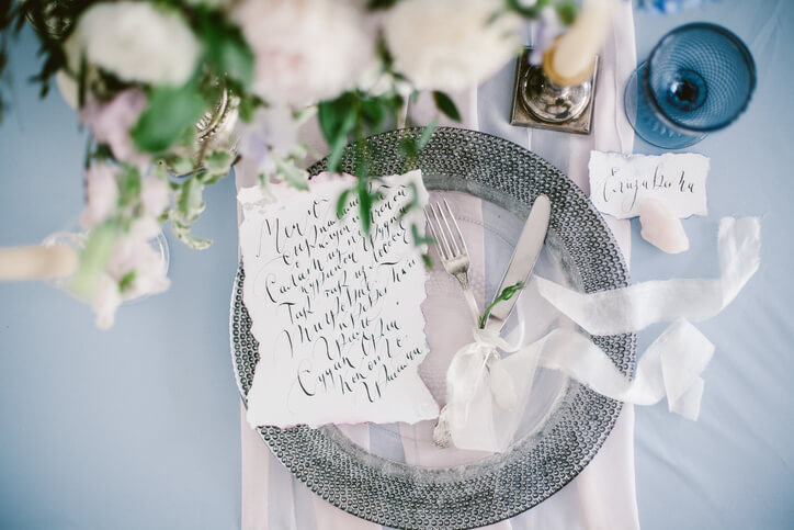 Beautiful wedding calligraphy cards and silver plate with cutlery.