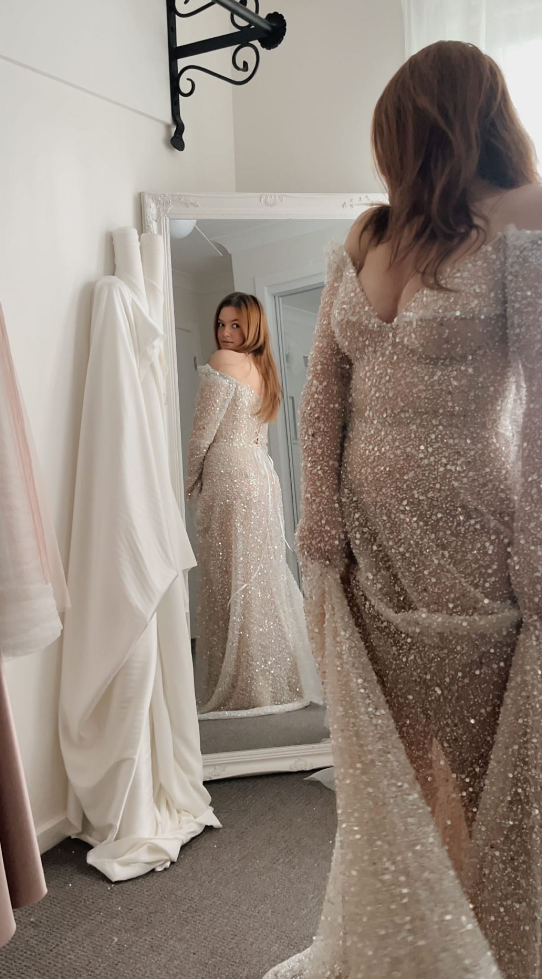 bride looks at herself in the mirror