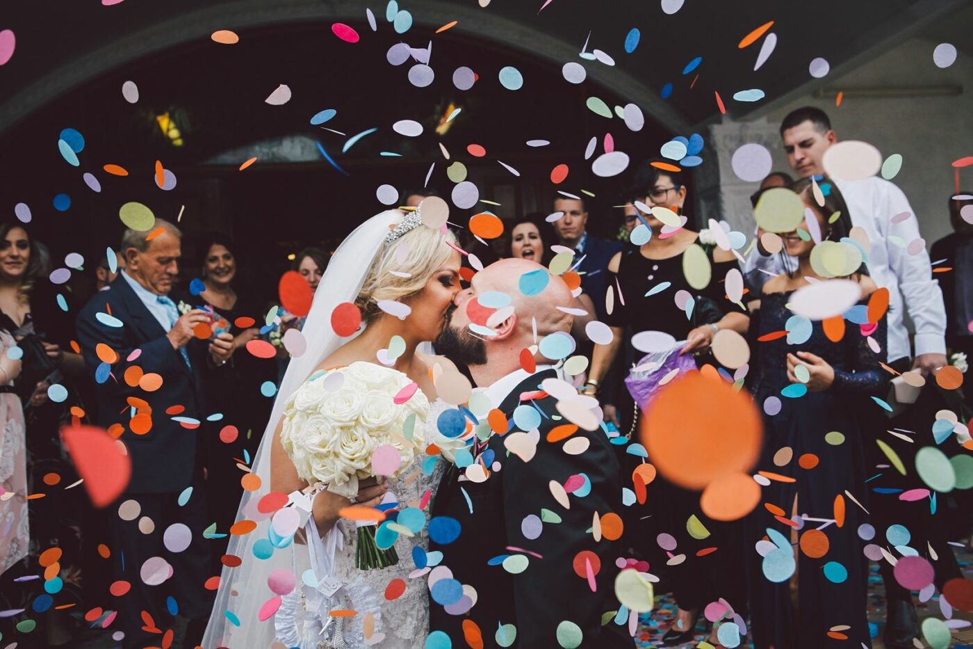 Newly wed couple under confetti