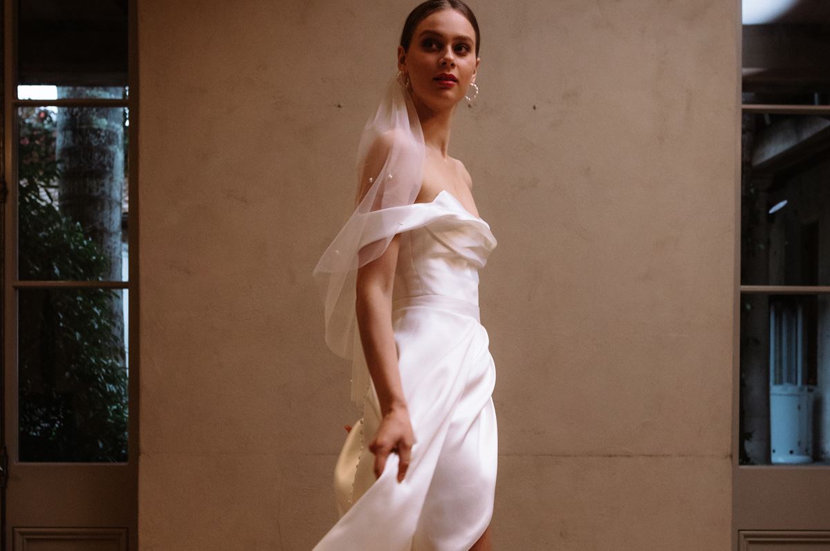 Bride wears a white silk wedding dress