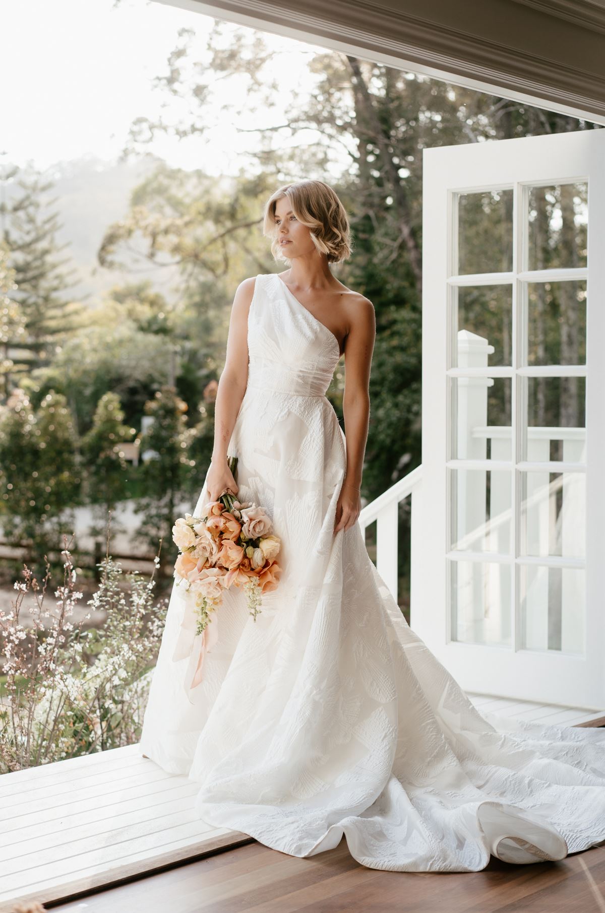 A bride stands in the doorway of Kwila Lodge