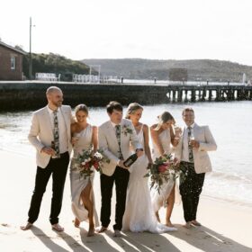 Beach wedding celebration with champagne and bridal party