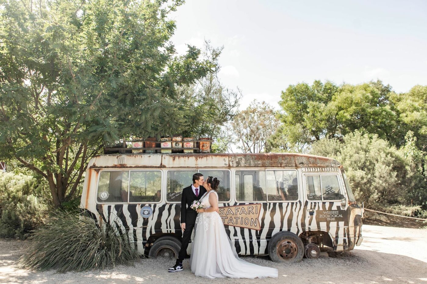 couple stands in front of wild van