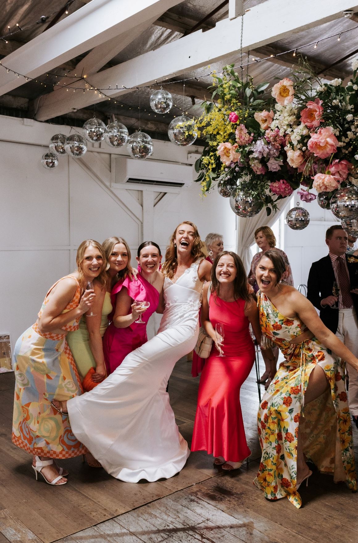 bride and her bridesmaids colourful dresses