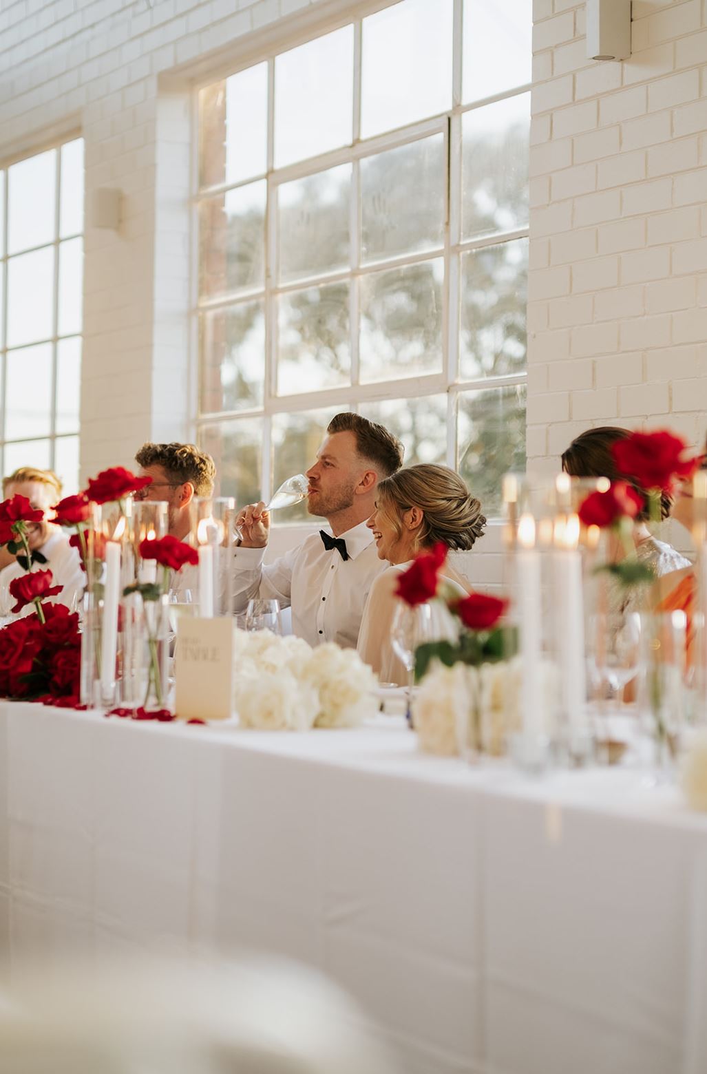 couple drinks chamapge on their wedding day