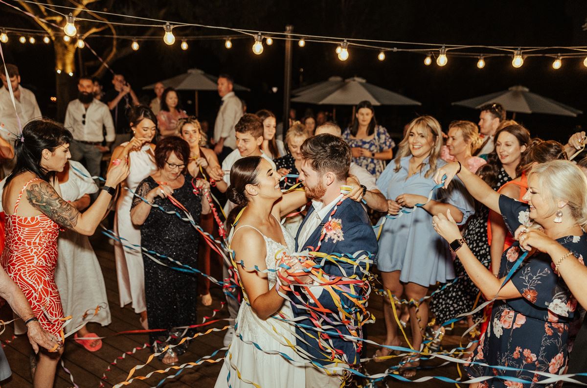 wedding party on the dancefloor with streamers wedding seating plan