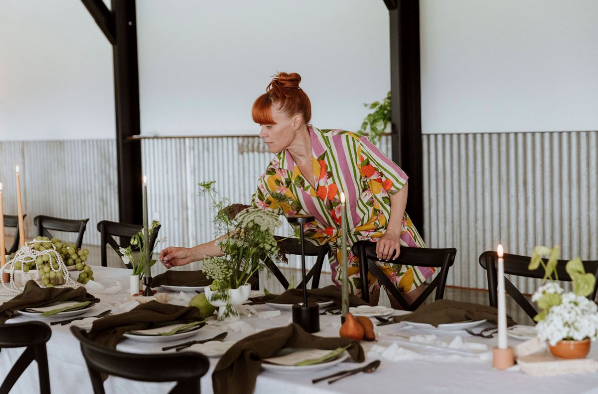 Advertise your wedding business wedding stylist setting up for boho wedding