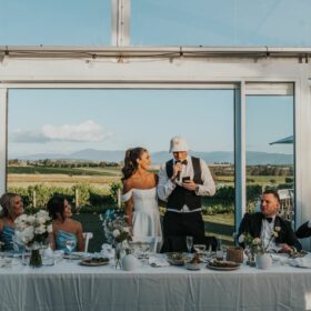 The groom and a wedding guest wearing personalised custom hats during a wedding celebration.