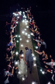 bride and groom are send off with sparkles
