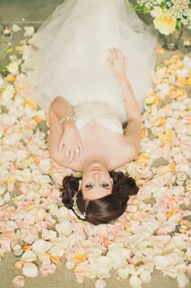 bride in a bed with rose petals