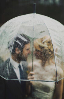 wedding couple under umbrella