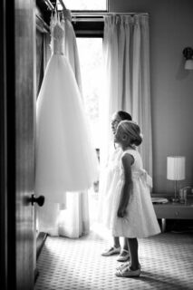 flower girls admiring the brides gown