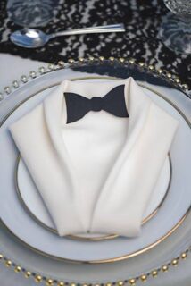 napkin folding - penquin themed wedding