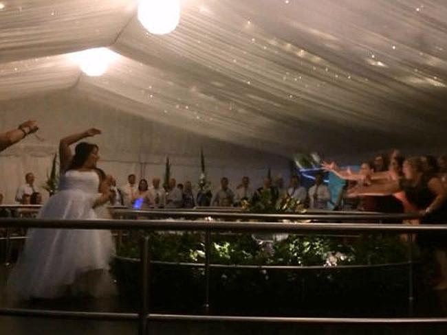 Bouquet toss: Guest dives over balcony to catch bouquet