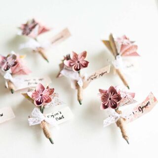 Origami buttonholes for wedding Image Anushe Low Photography|Place-and-name|origami buttonhole|Fortune teller wedding menu|seating chart made of origami|chair origami wedding|origami bouquet||||Wedding cake origami Image Anushe Lowe|paper crane origami wedding decorations|origami hanging centrepiece for wedding|origami wedding dress by jasper gardiva