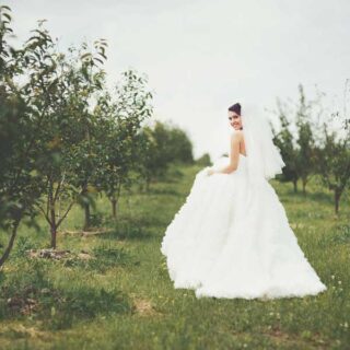 Portrait of beautiful charming young lady in flower wreath and|Beautiful Girl in Gown and Diamond Earrings|Bouquet in Pink and Hands||silk satin wedding dress material|Groom hugging bride