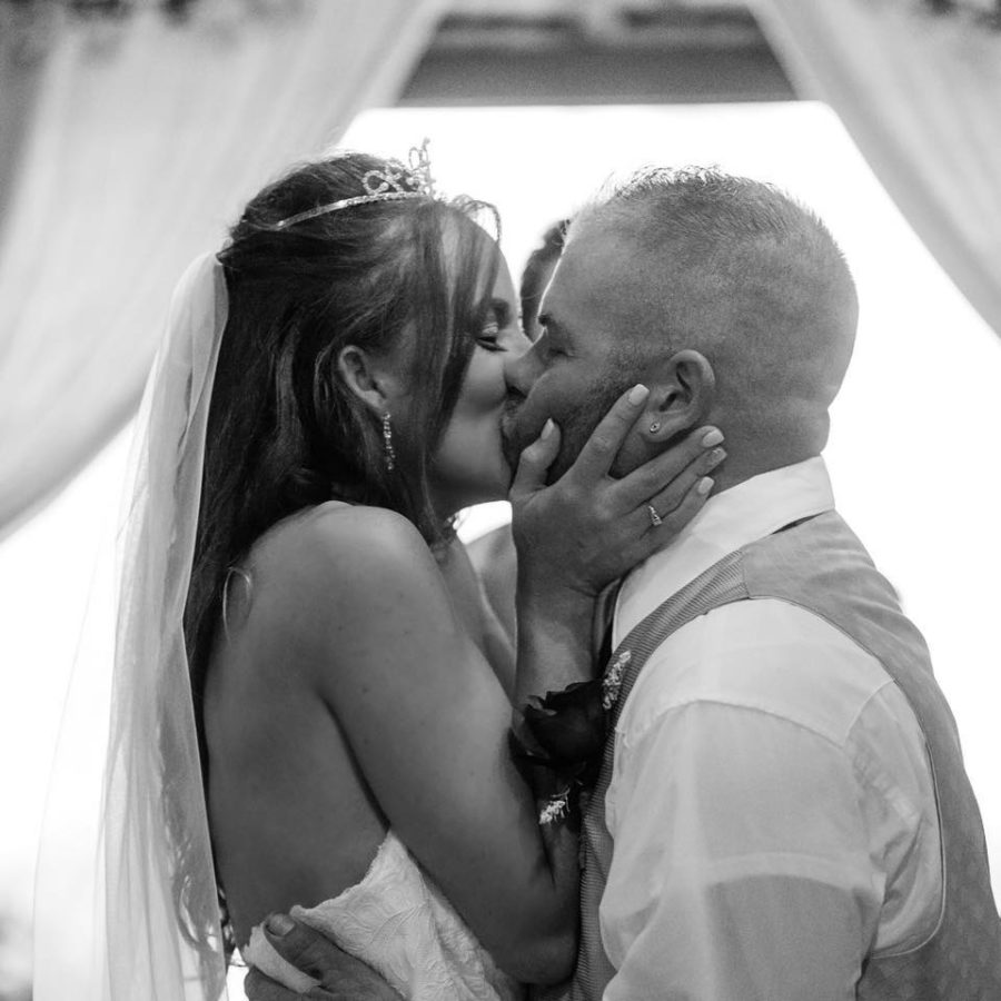 Photographer pushes brides stepmum out of the way to capture couples first kiss as married couple